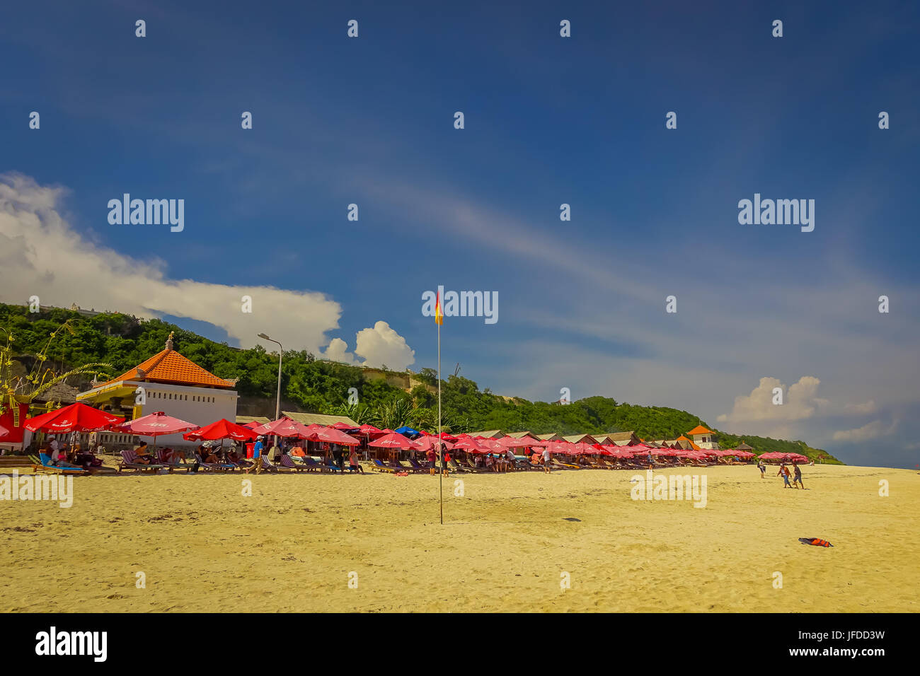 Beautiful sunny day with umbrellas in a row in the beach of Pantai ...