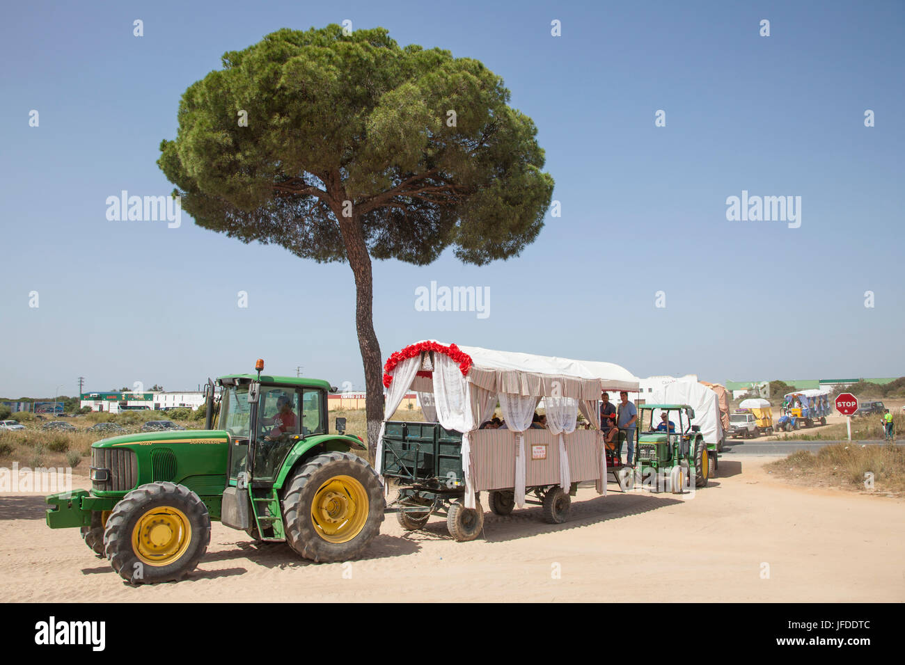 El Rocio, Spain - June 2, 2017: Pilgrims with tractor trailers on the road to El Rocio during the pilgrimage Romeria 2017. Province of Huelva, Andalus Stock Photo