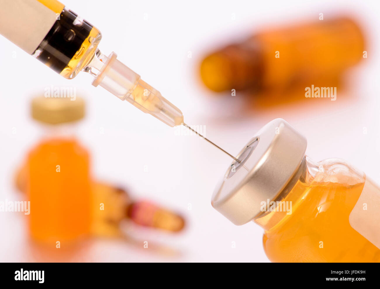 vaccination with syringe and serum Stock Photo