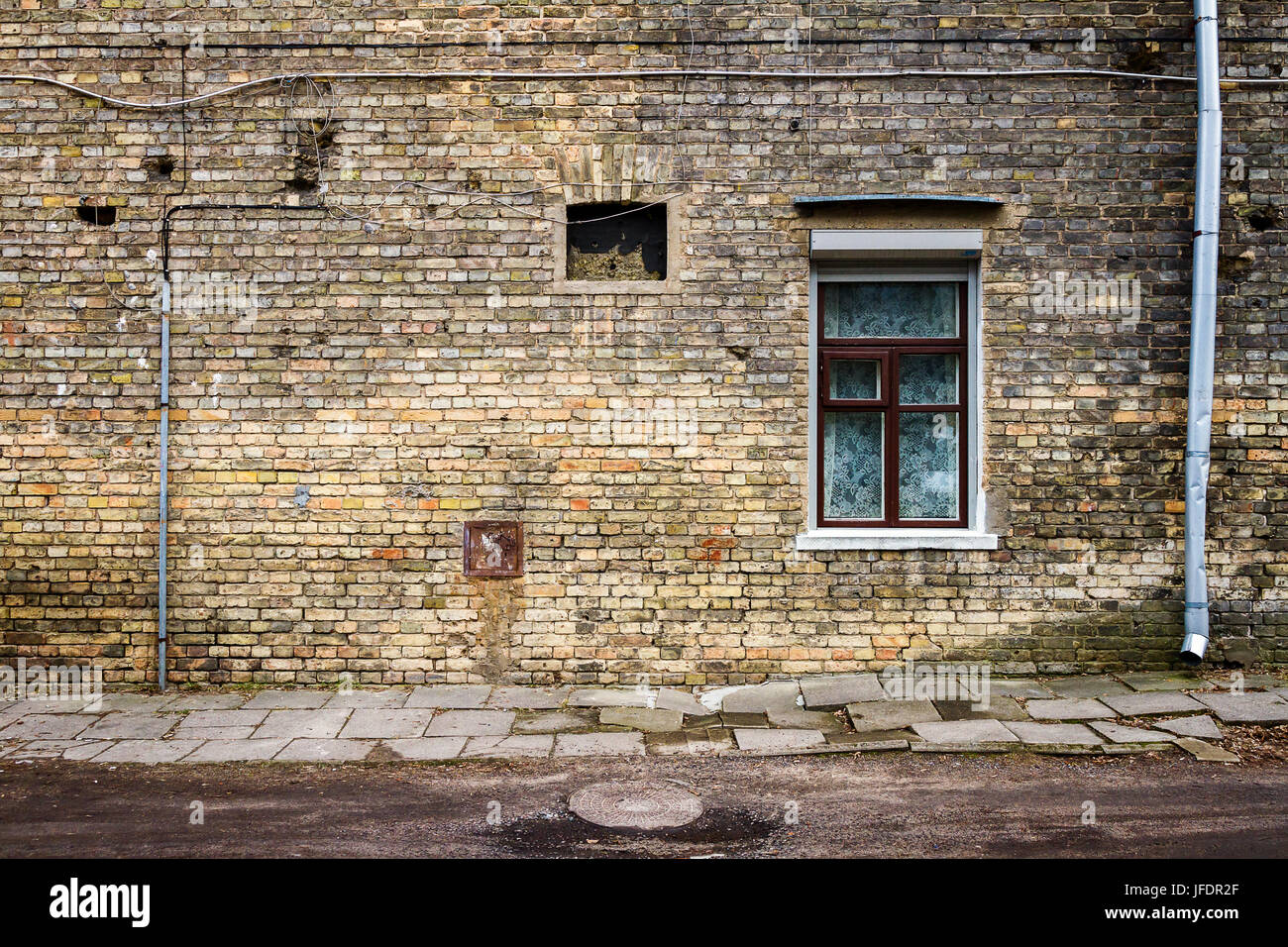 Aged weathered street wall with a windows. Architecture detail background.  Old yellow brick wall Stock Photo - Alamy
