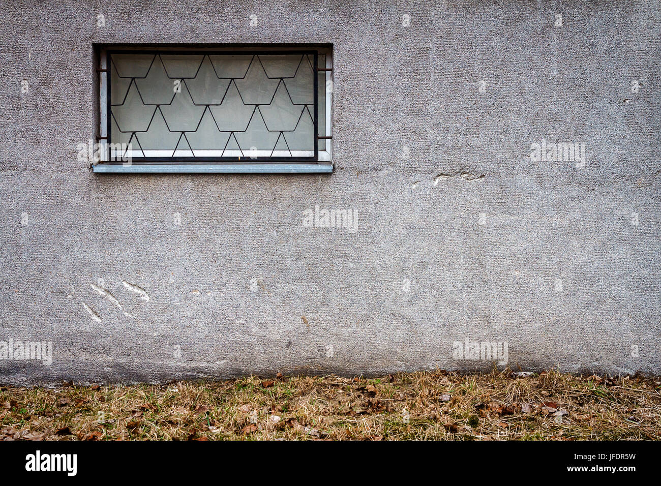 Concrete wall with a window and ground. Architecture background Stock