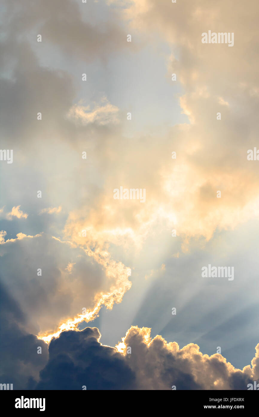 Clouds and sun beams on evening time Stock Photo