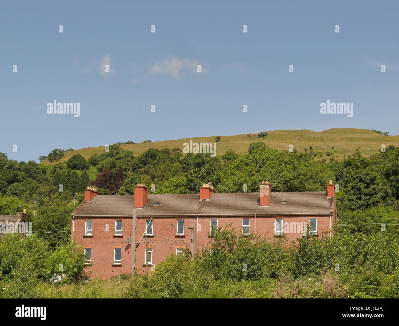 Bowling tenements with Kilpatrick hills blue sky Stock Photo