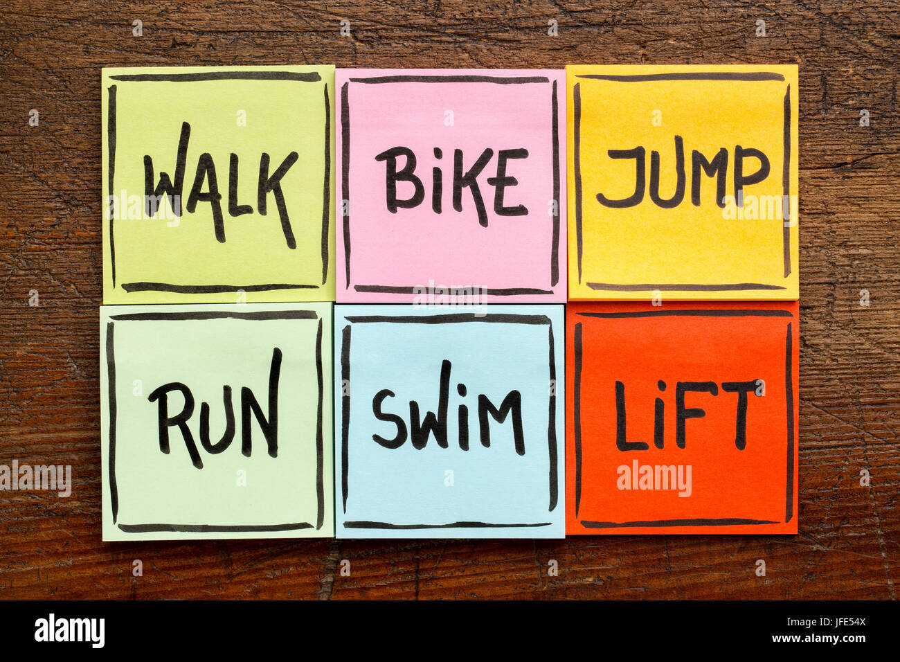 walk, bike, jump, run, swim, life - fitness or cross training concept - handwriting on sticky notes against rustic wood Stock Photo