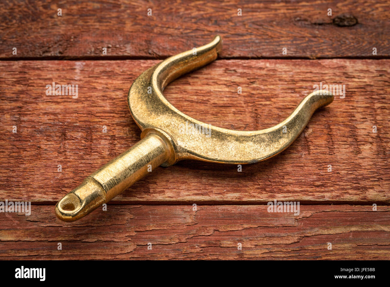 brass rowlocks (oarlock) on rustic weathered barn wood background Stock Photo