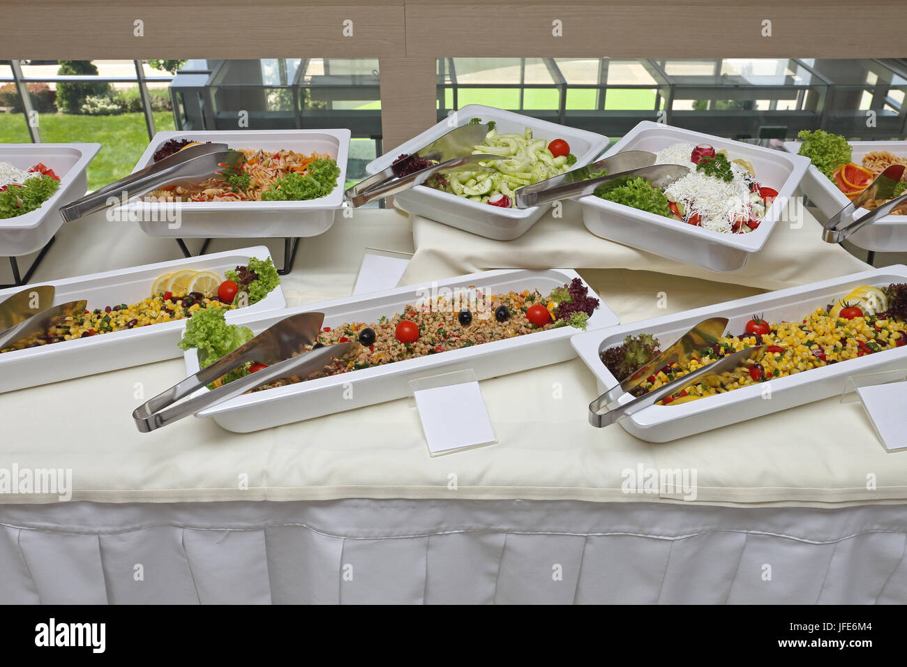 Grilled corn and baked potatoes stuffed with cheese in hotel pan on food  warmer. Self-service buffet table. Celebration, party, birthday or wedding  Stock Photo - Alamy