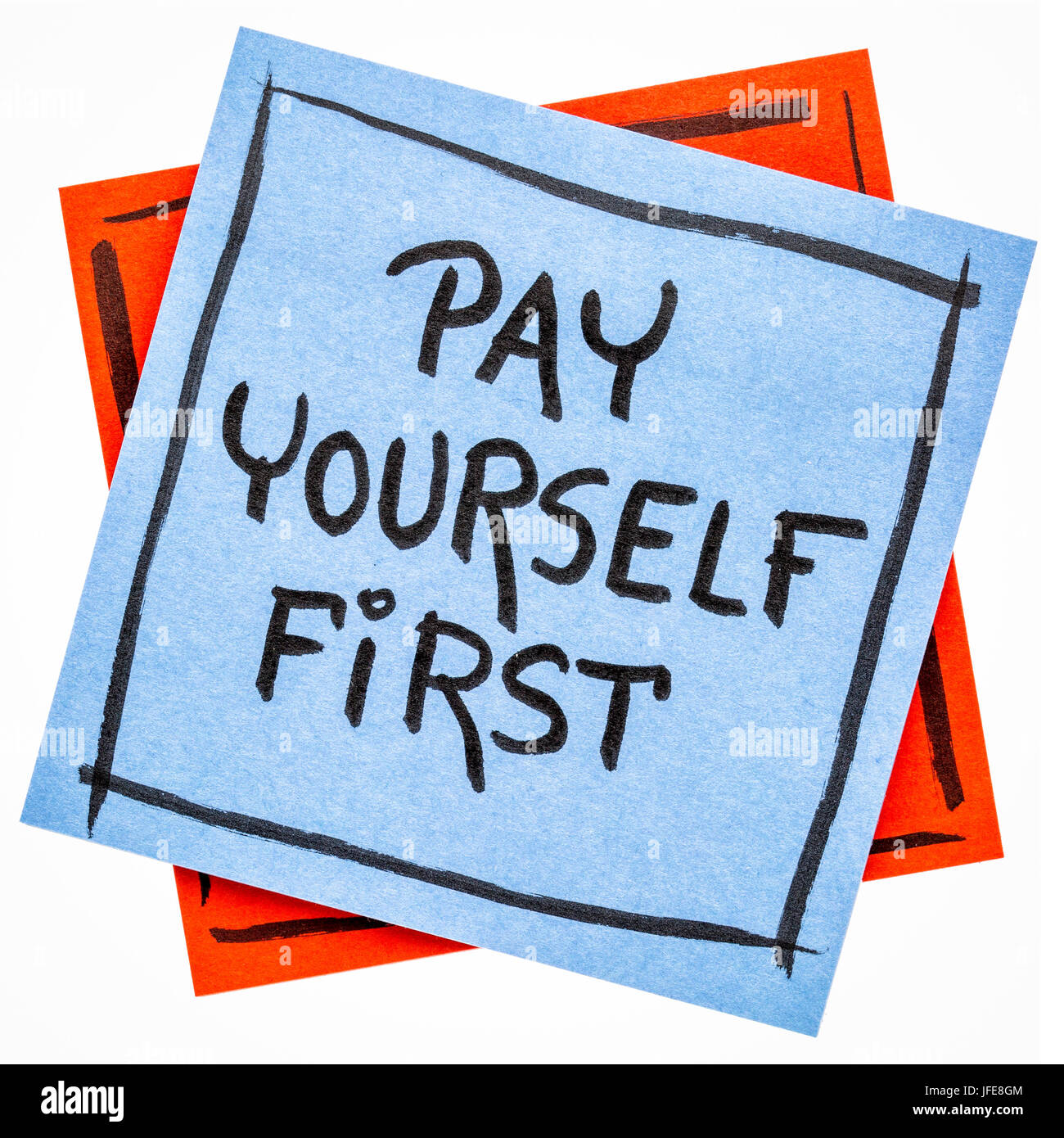 pay yourself first, a reminder of personal finance strategy - handwriting on an isolated sticky note Stock Photo