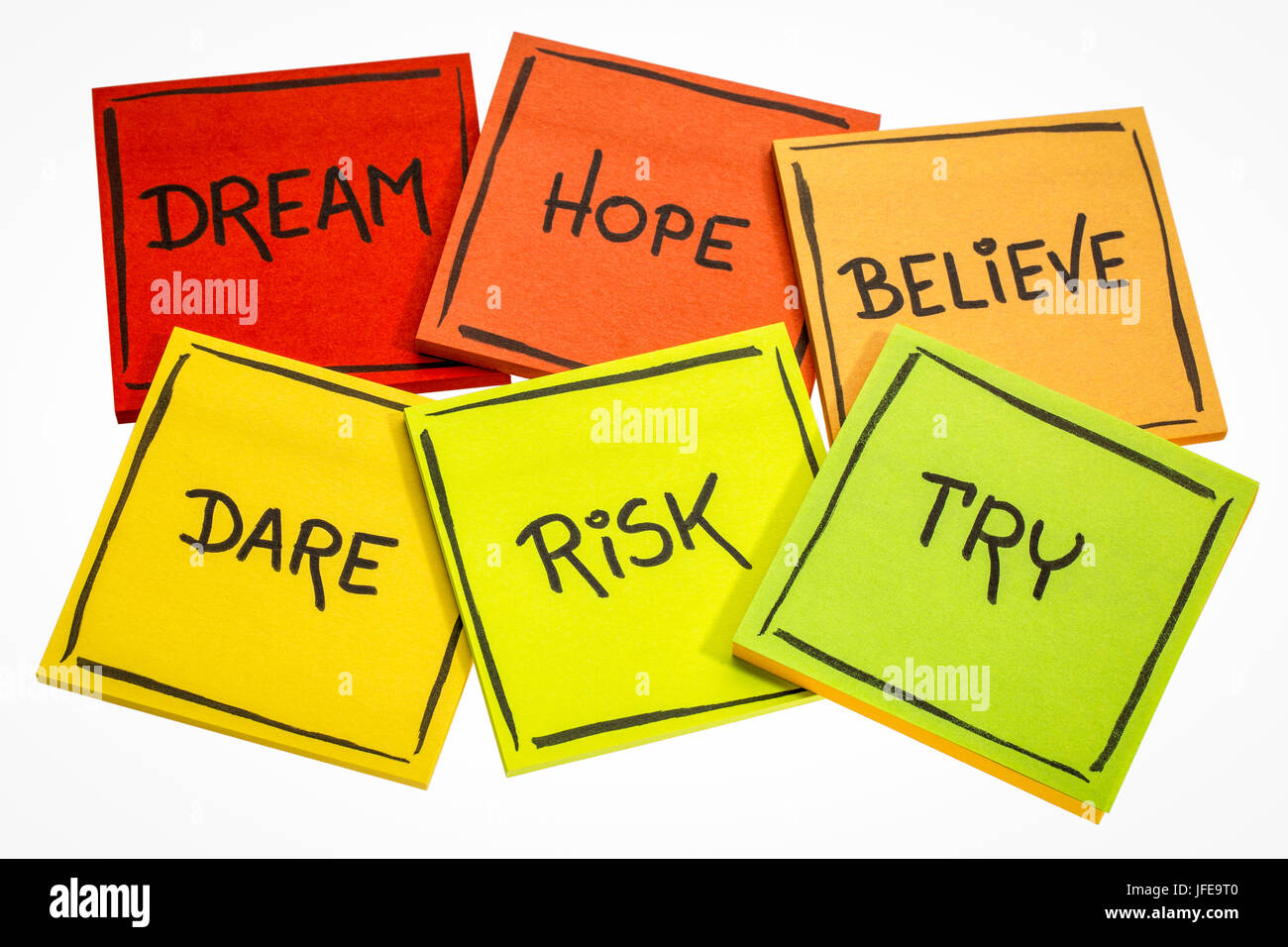 dream, hope, believe, dare, risk, try - motivational concept - a set of isolated sticky notes with handwriting Stock Photo