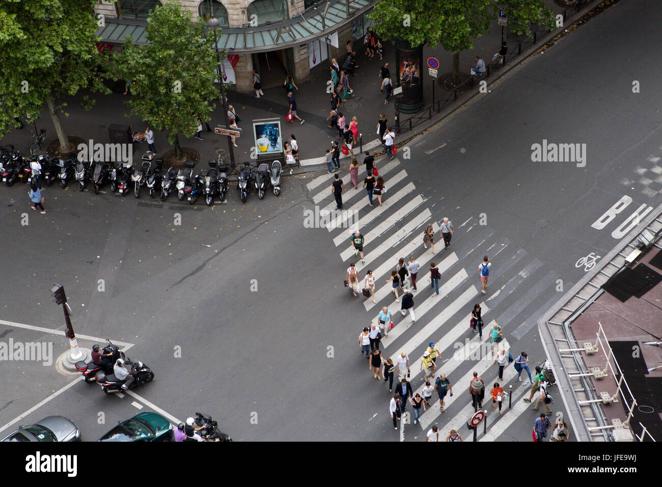 Pedestrians in a crosswalk near the Paris Opera House, Garnier Palace. Stock Photo