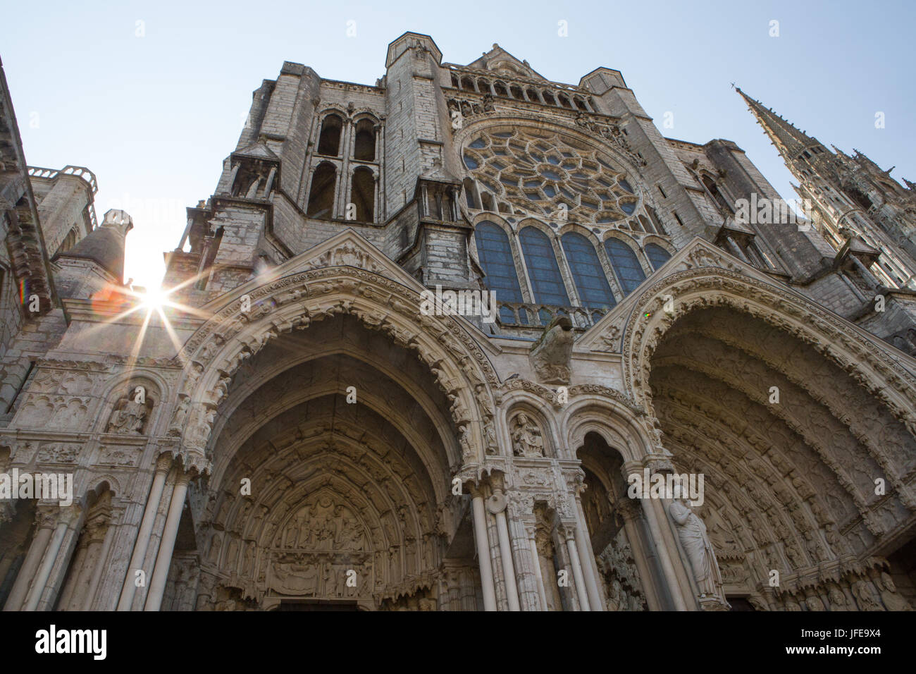 The sun bursts from behind the Cathedral Basilica of our Lady of Chartres. Stock Photo
