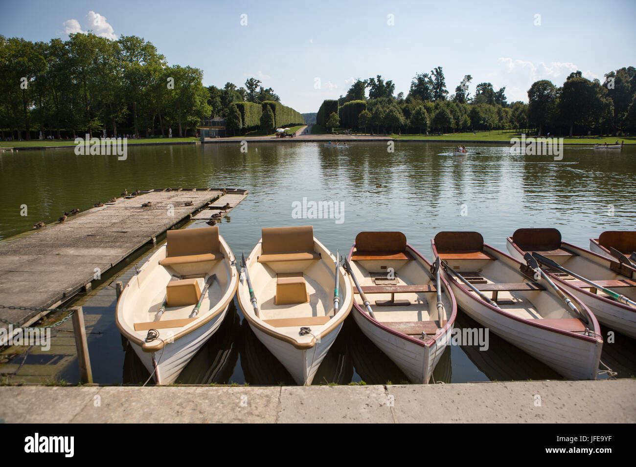 Boats for rent sit at the dock in the Grand Canal at Versailles. Stock Photo