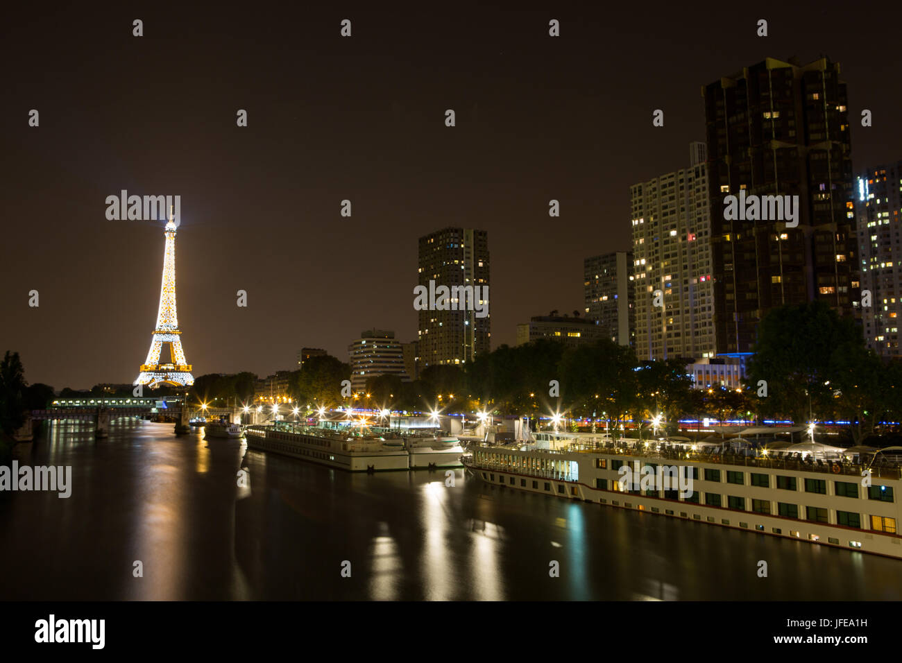 The Eiffel Tower Seine River And Paris Cruise Boats At Night