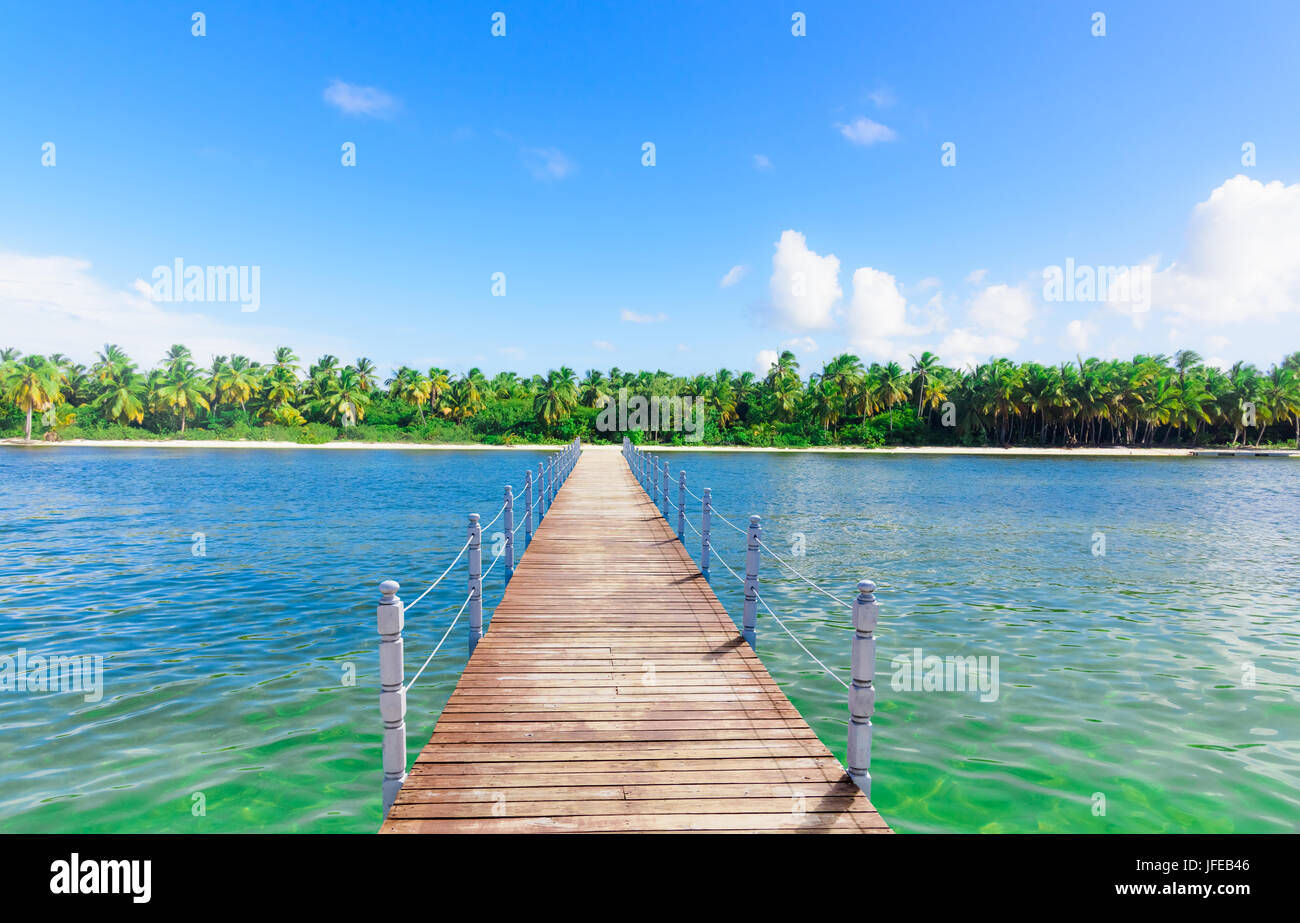 wooden bridge juts out into  of the sea Stock Photo