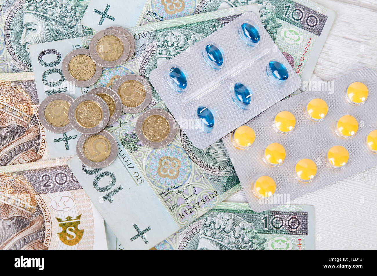 Pills and polish zloty bills. medicine pills health cost polish money zloty pln concept Stock Photo