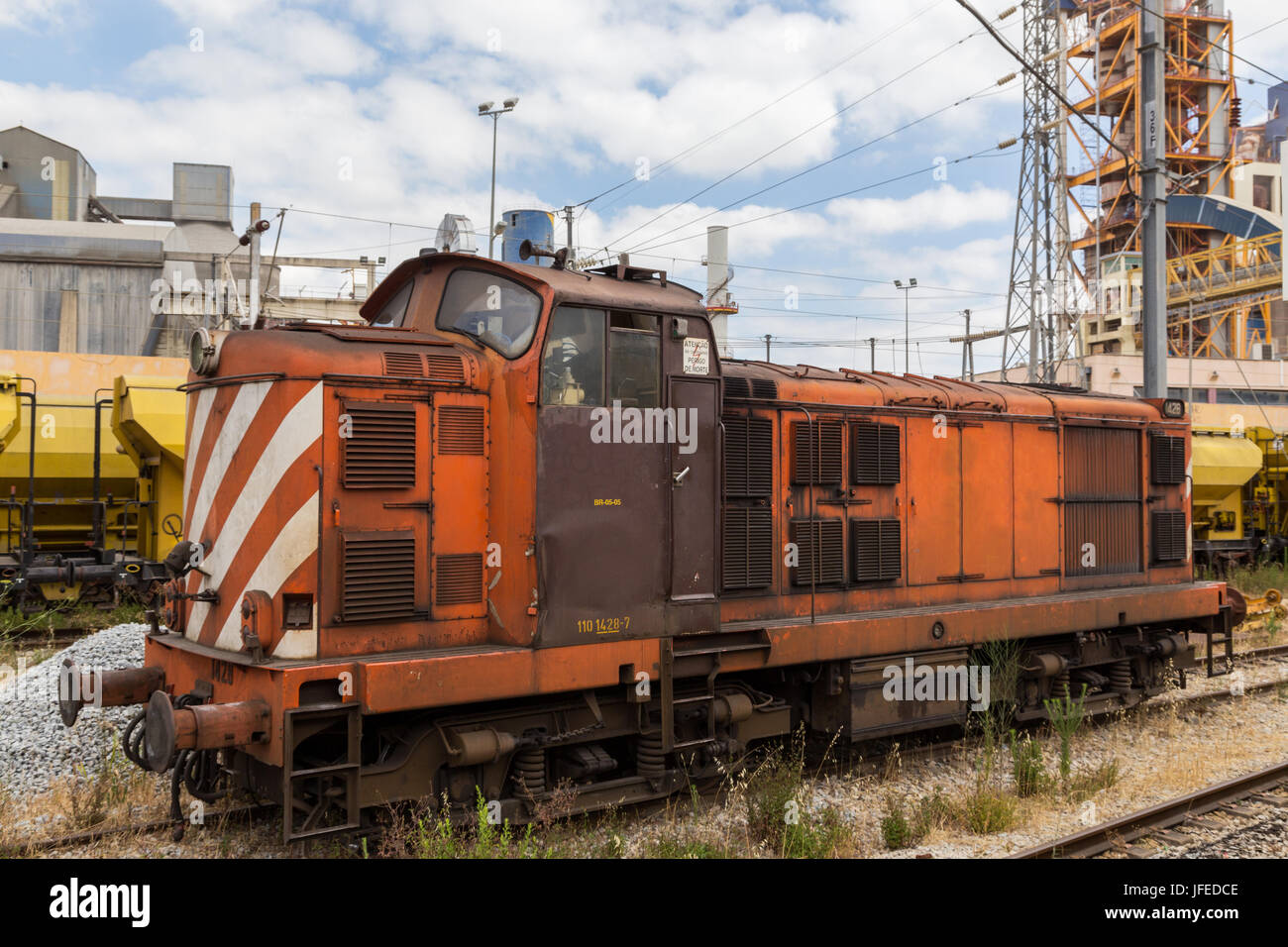 heavy train wagon with industrial building factory Stock Photo - Alamy