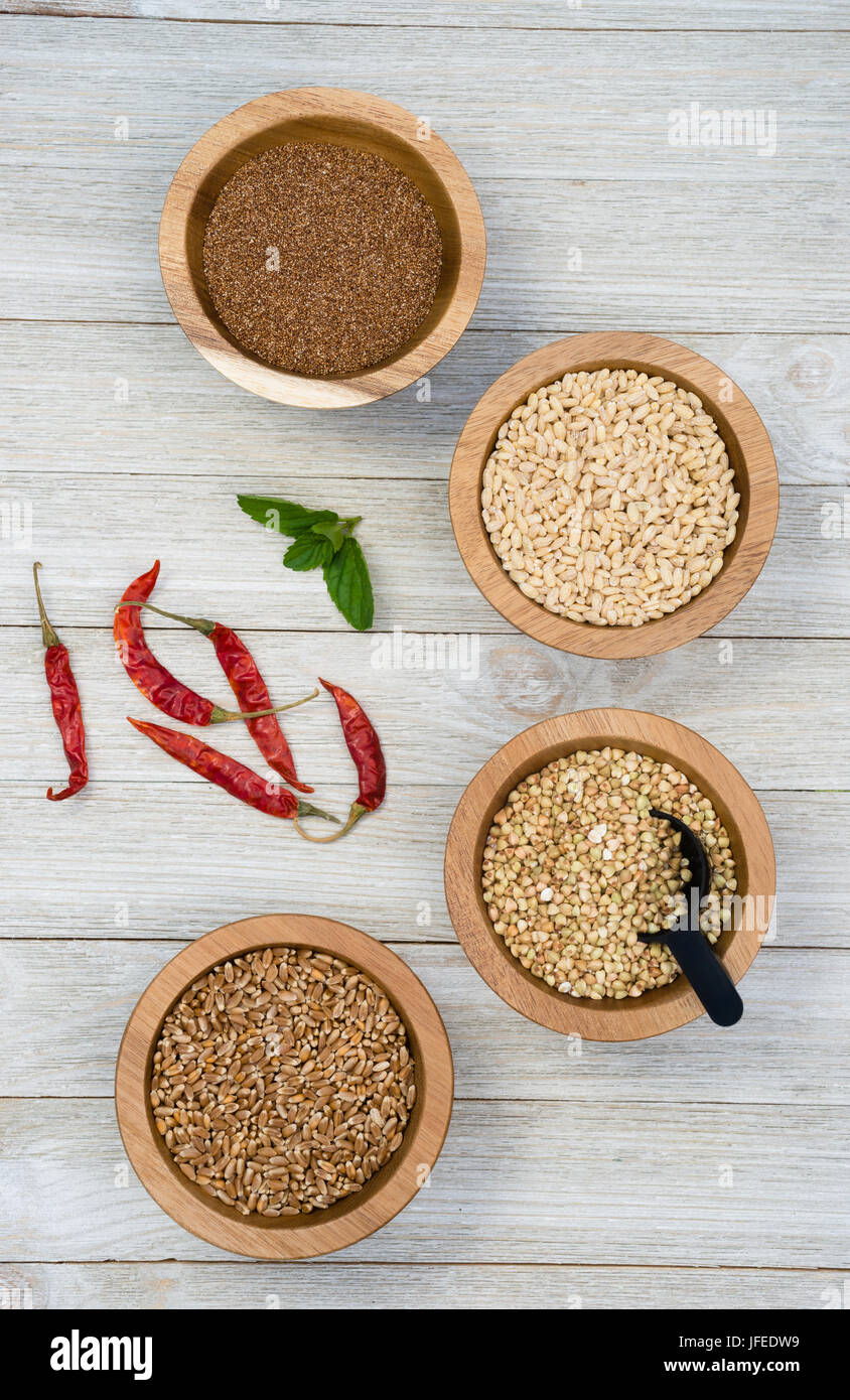 Wheat Berries Buckwheat Groats Pearl Barley Farrow in Bowls with Red