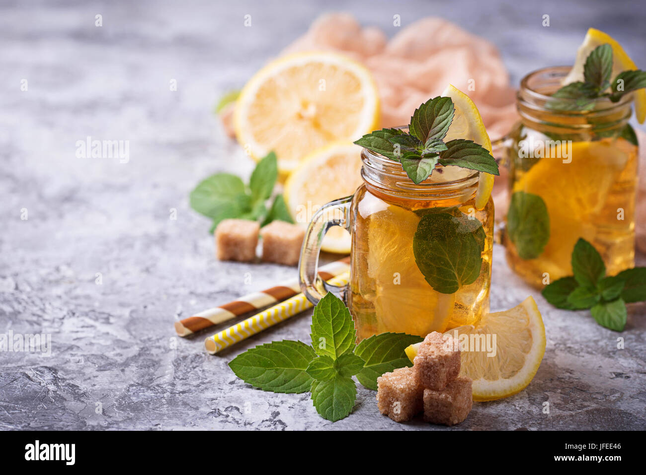 Refreshment Using Tea Iced tea with lemon and mint. Refreshment summer drink. Selective focus ...