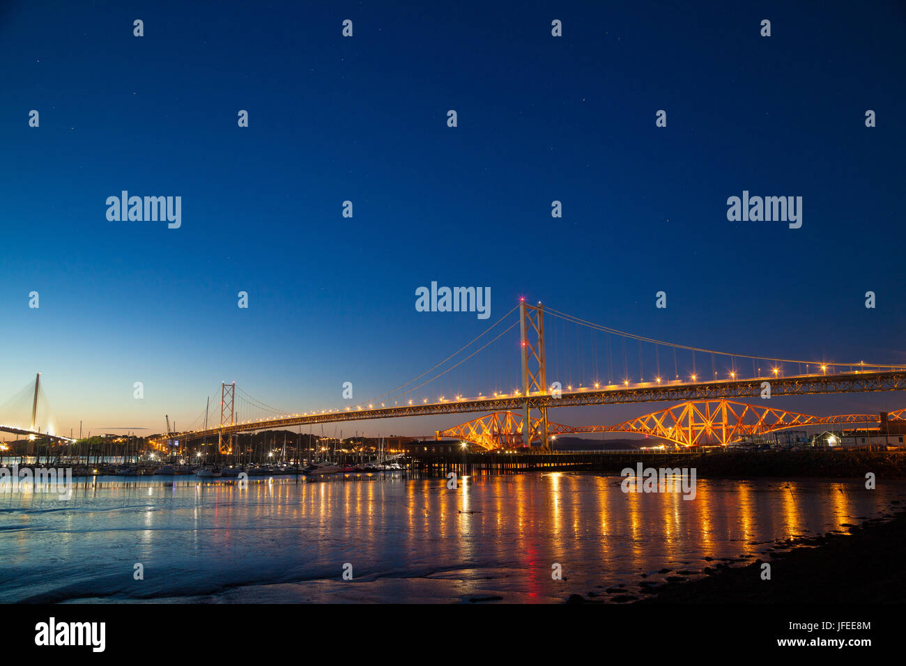 The Forth Road and Rail Bridge at night near Edinburgh Stock Photo