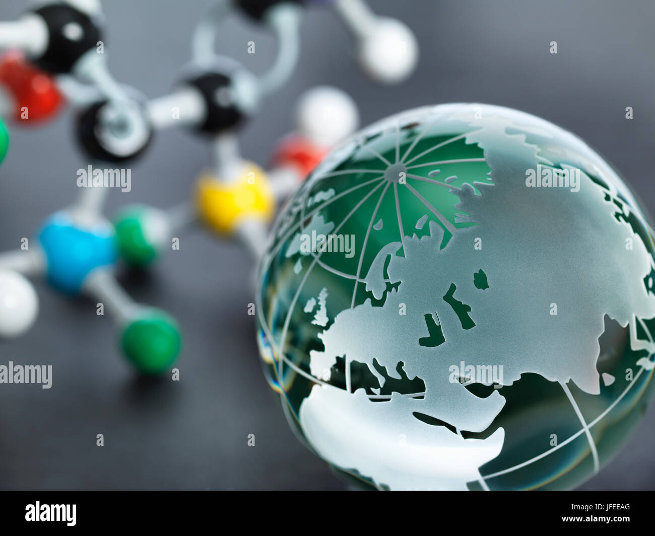 Global research, conceptual image. Glass globe and molecular model