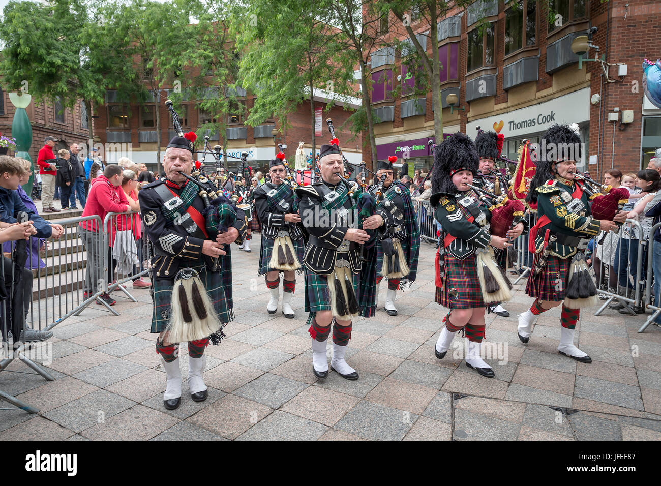 Pipers in the Northenden Pipe Band marching through the town centre on Warrington Walking Day Stock Photo