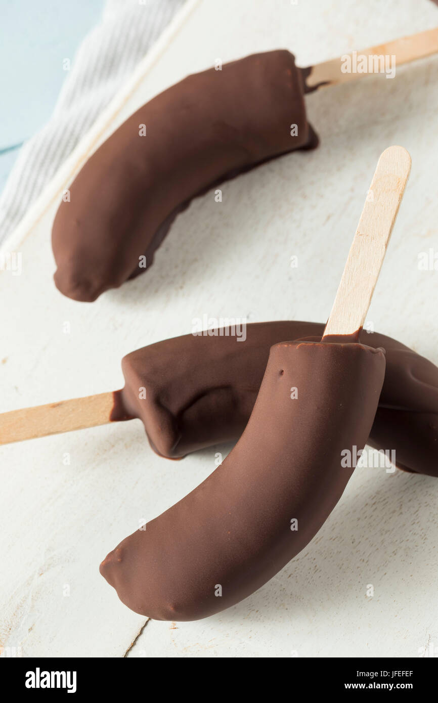Homemade Frozen Chocolate Covered Bananas on a Stick Stock Photo
