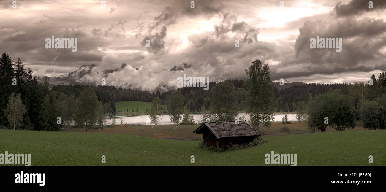 Austria, Tyrol, Kitzbuehel, black lake, clouds, Stock Photo