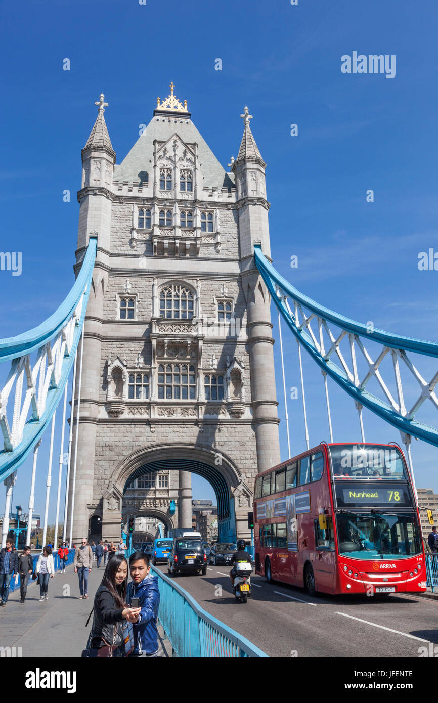 England, London, Tower Bridge, Asian Tourists Taking Photo Stock Photo