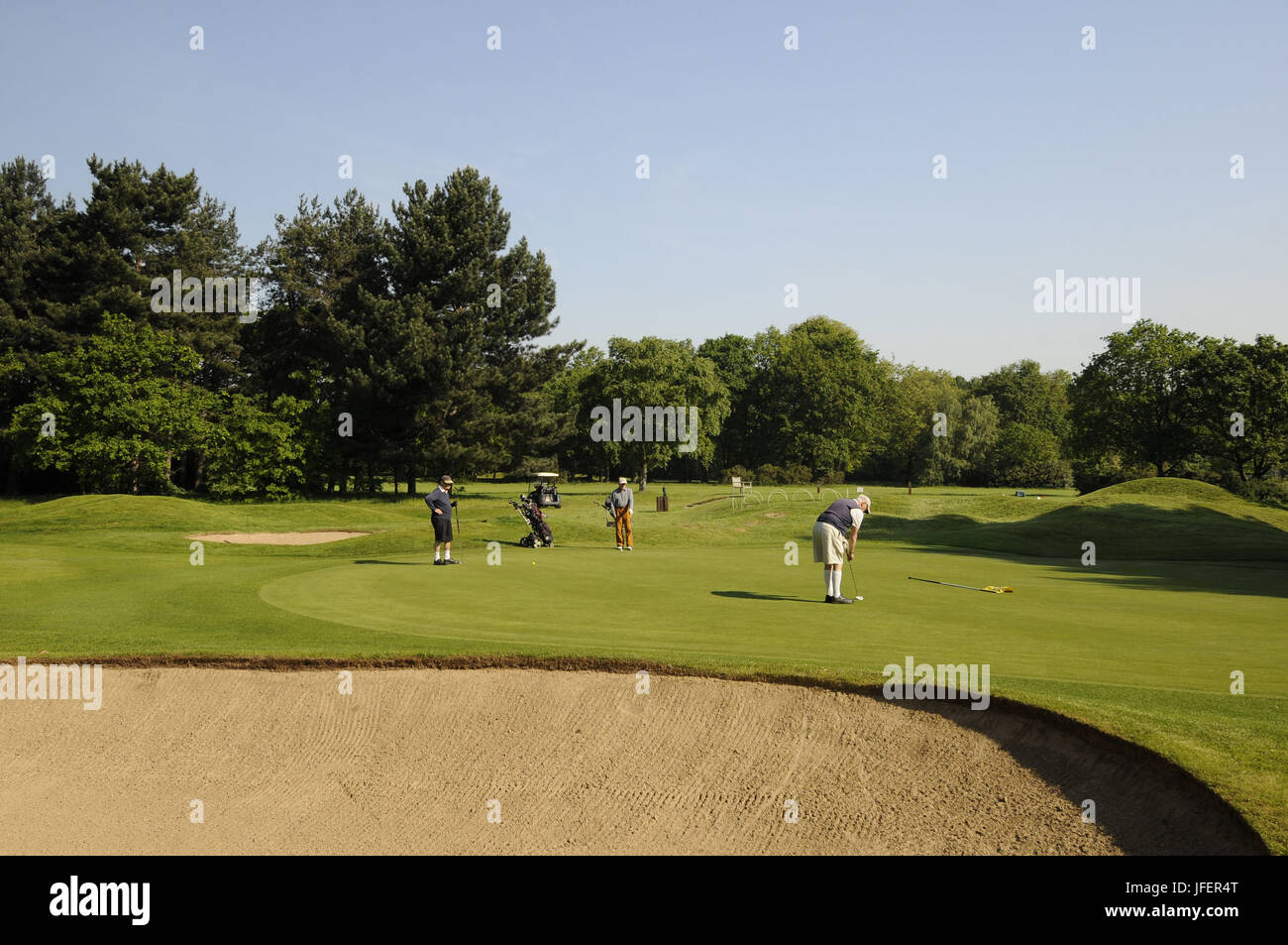 Golfers putting on the 2nd Green on Pam Barton Course Royal Mid-Surrey Golf Club, Richmond, Surrey, England Stock Photo