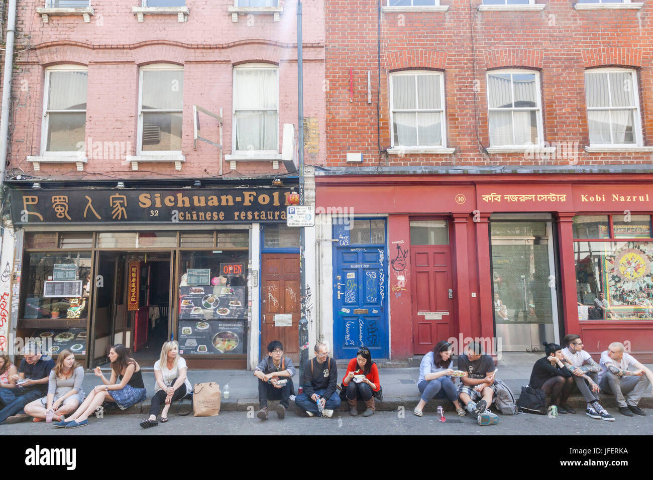 England, London, Tower Hamlets, Brick Lane, Brick Lane Market, People Eating Takeaway Food Stock Photo