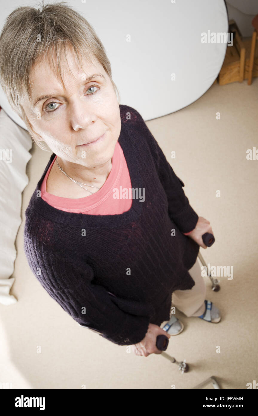 woman with crutches serious Stock Photo