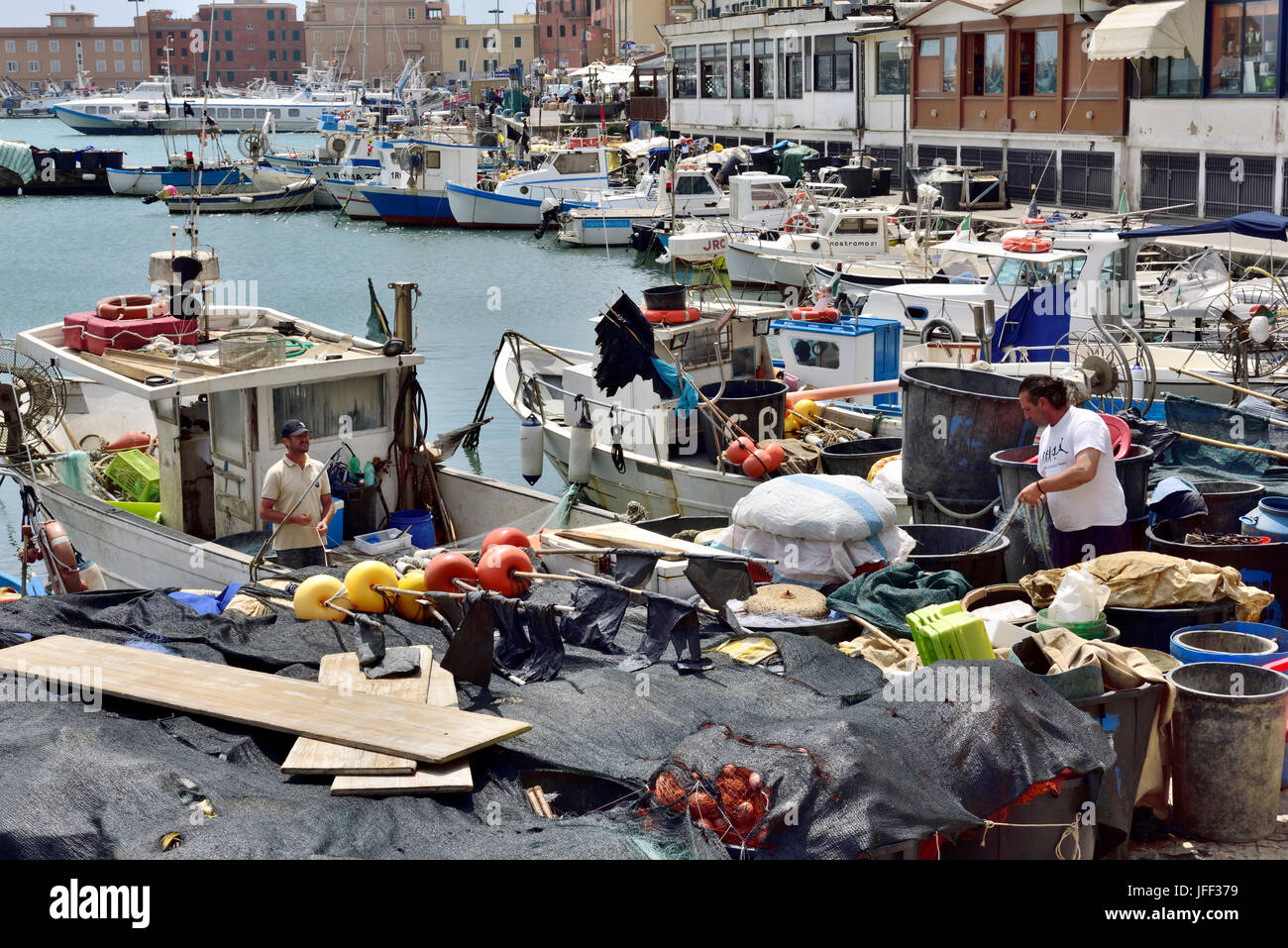 Fishermen working on quayside sorting trawler nets Anzio, Italy Stock Photo