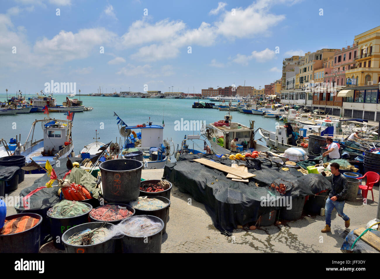 Trawler fishing boats moored with nets on quayside Anzio, Italy Stock Photo