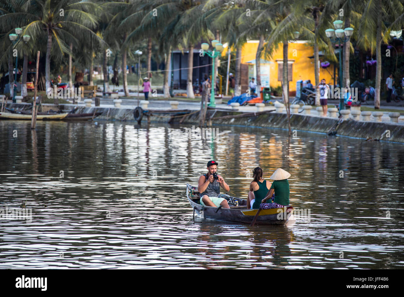 Tourists in a rowboat on the Thu Bon River in Hoi An, Vietnam Stock Photo