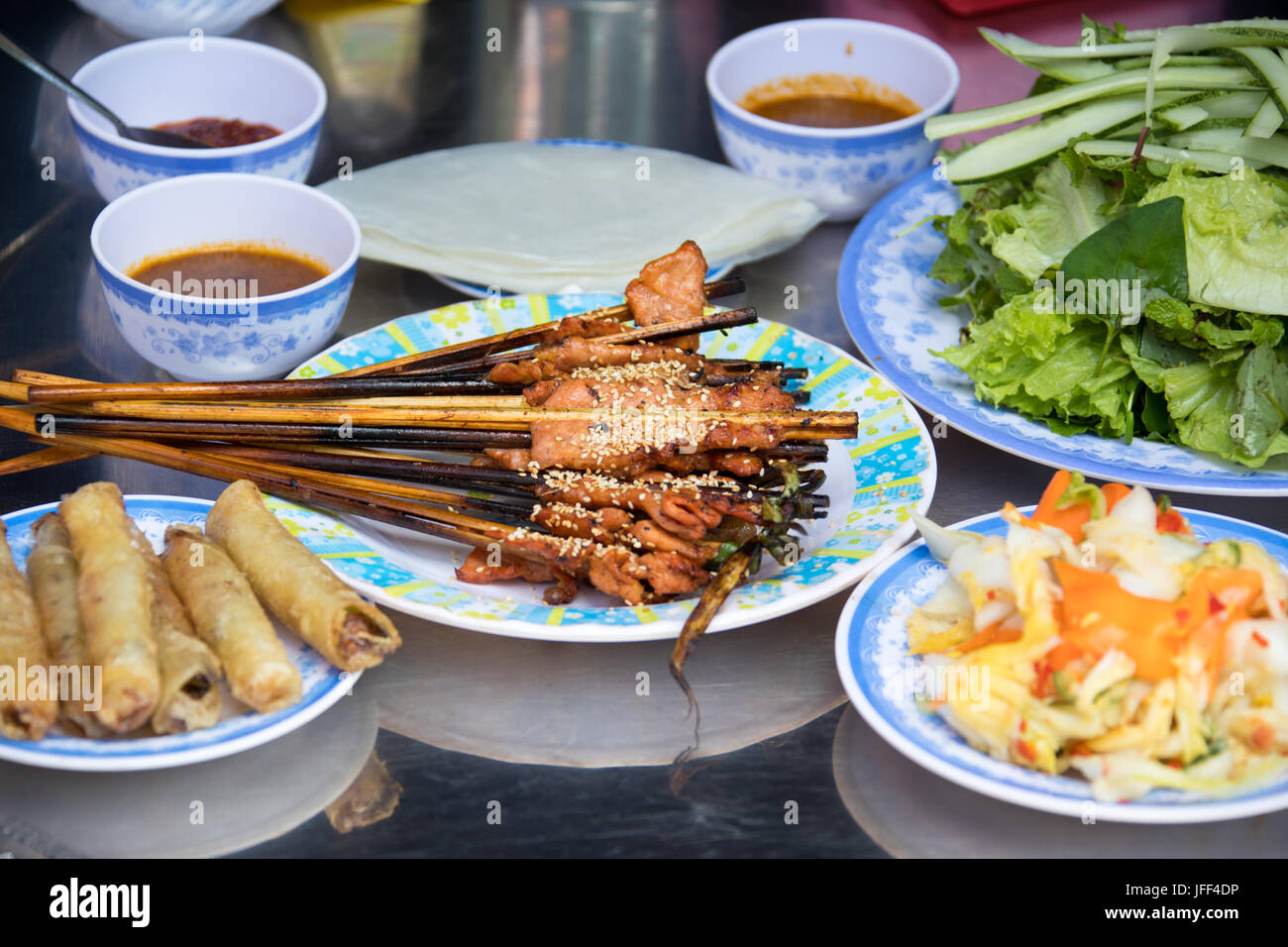 Grilled pork served with soft rice paper and vegetables, Hoi An, Vietnam Stock Photo