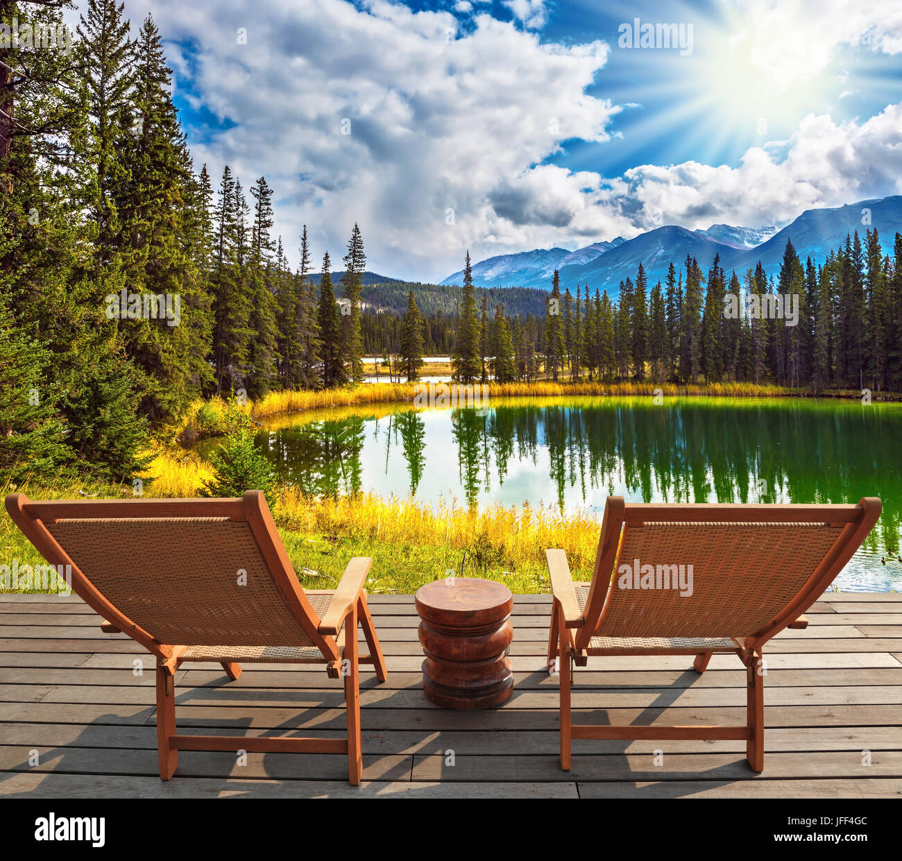 Two wooden deckchairs on the shore of lake Stock Photo - Alamy