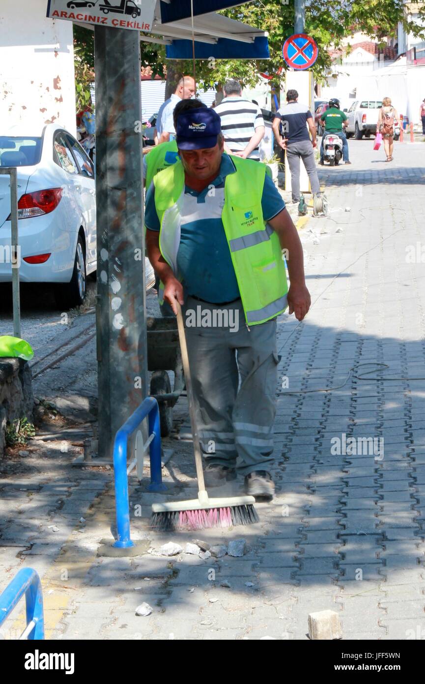 A Turkish worker sweeping debri after working in a street in fethiye, turkey Stock Photo