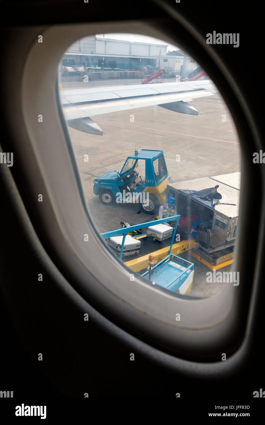 Luggage being loaded into airplane Stock Photo