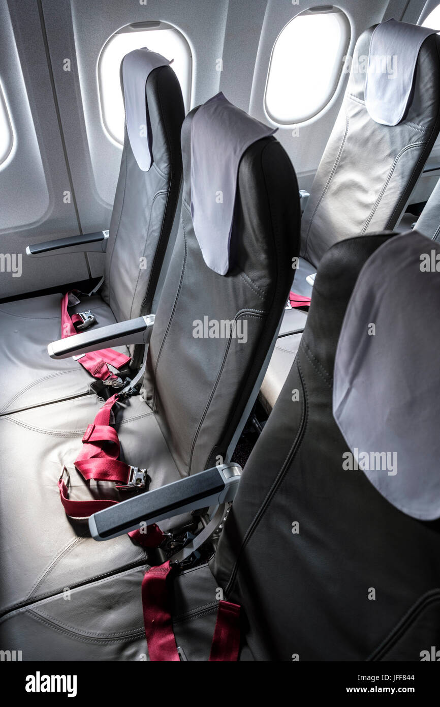 Rows of empty seats inside a commercial airliner Stock Photo
