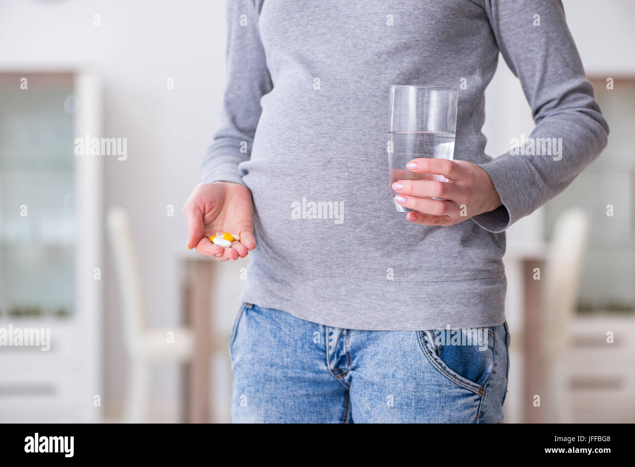 Pregnant woman taking pills during pregnancy Stock Photo Alamy