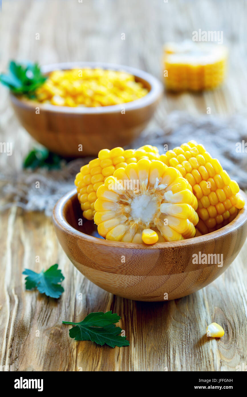 Corn cob cut into a wooden bowl. Stock Photo