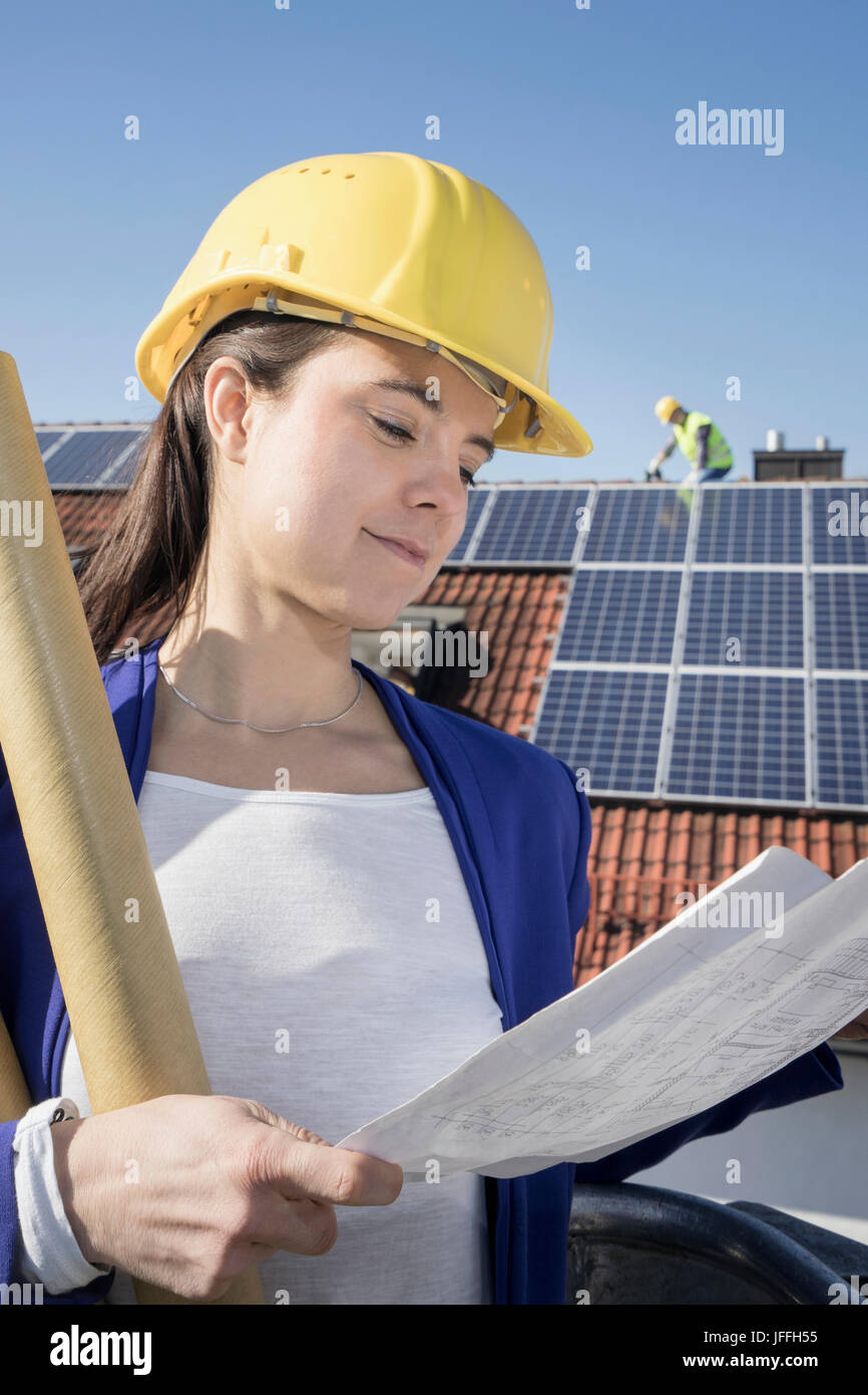 Female engineer controlling installation of solar panels Stock Photo ...