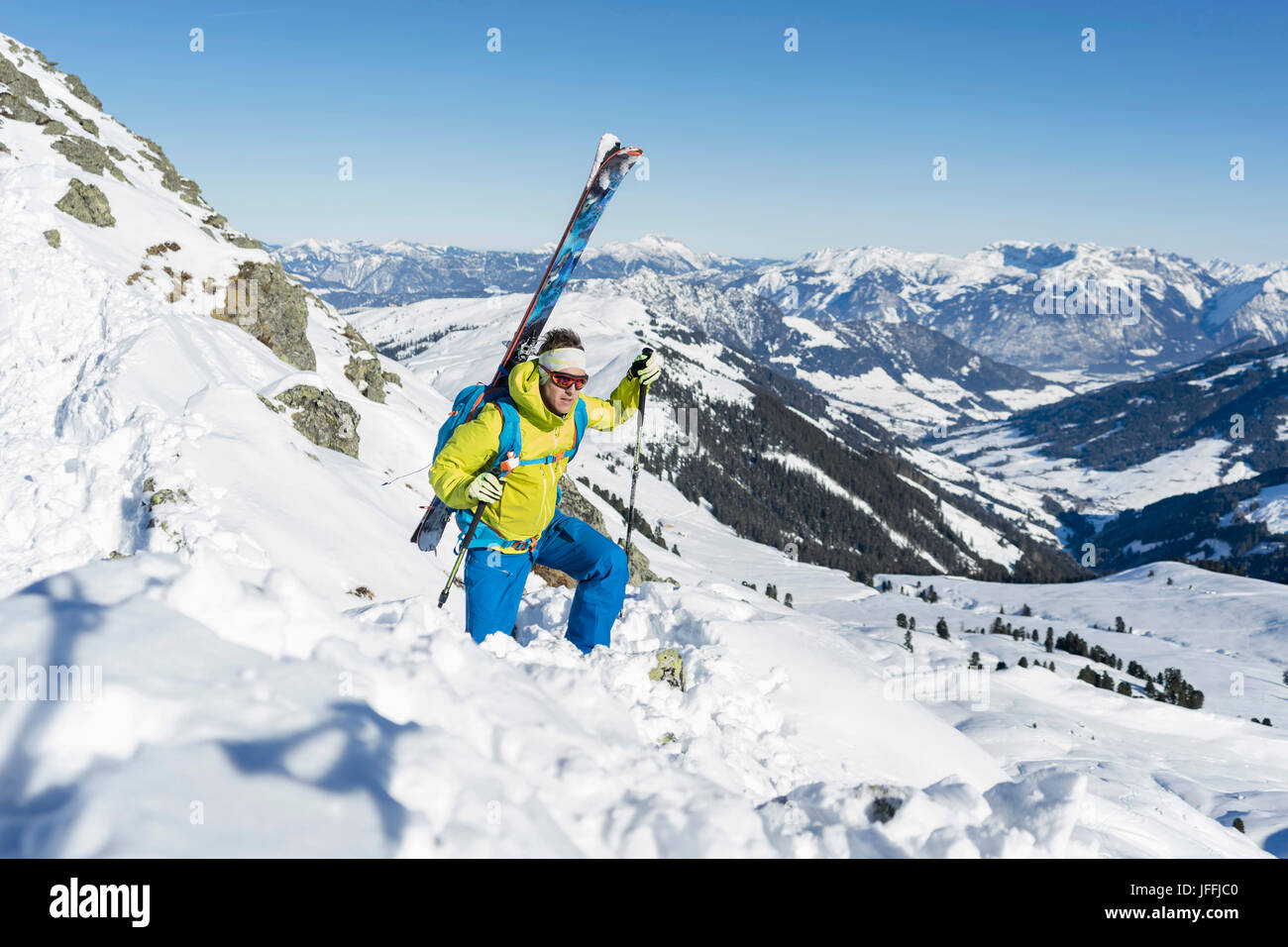 Skier climbing up on ridge of snow mountain Stock Photo - Alamy
