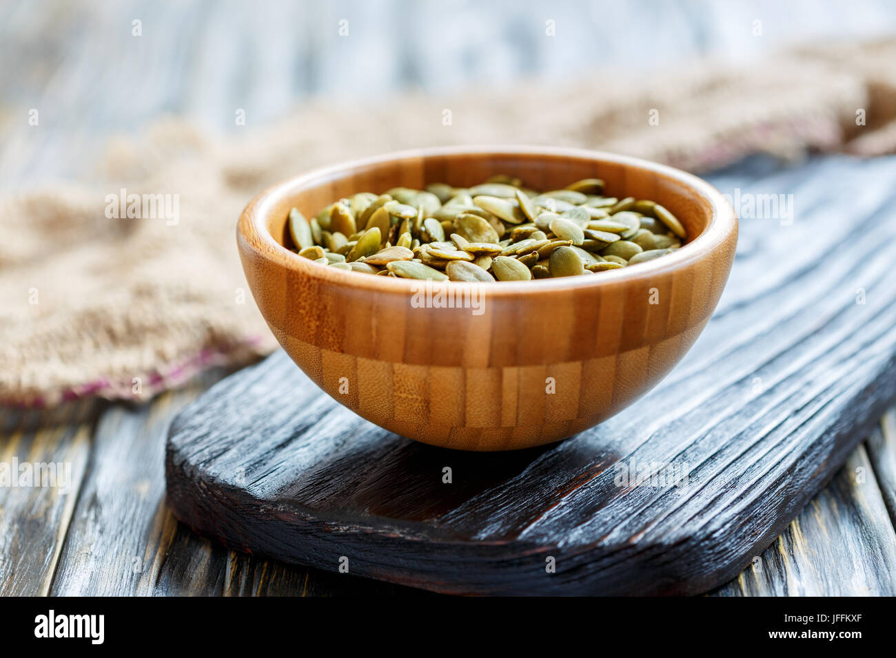 Cleaned the pumpkin seeds in a wooden bowl. Stock Photo