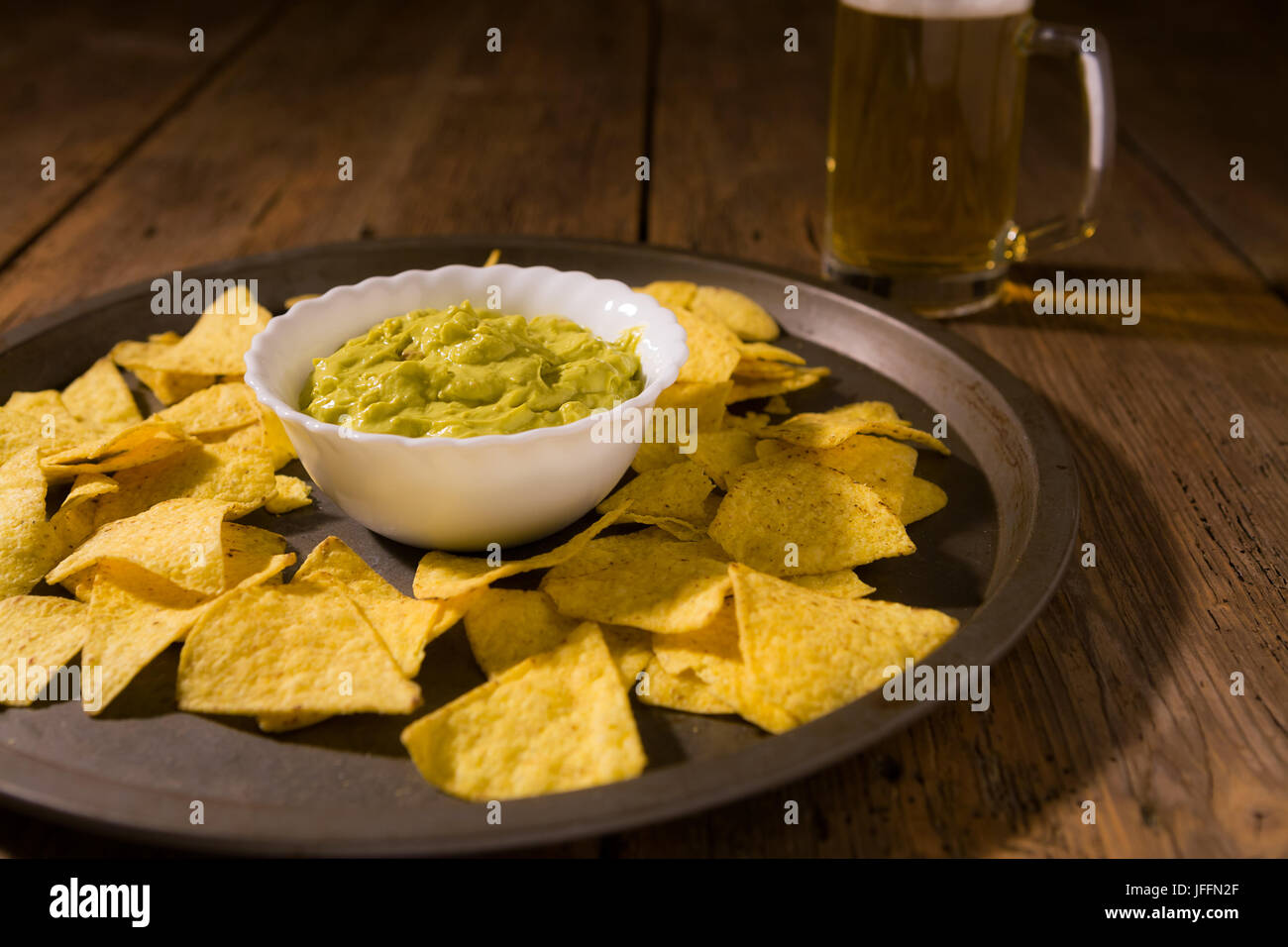 Nachos chips, salsa guacamole and beer Stock Photo