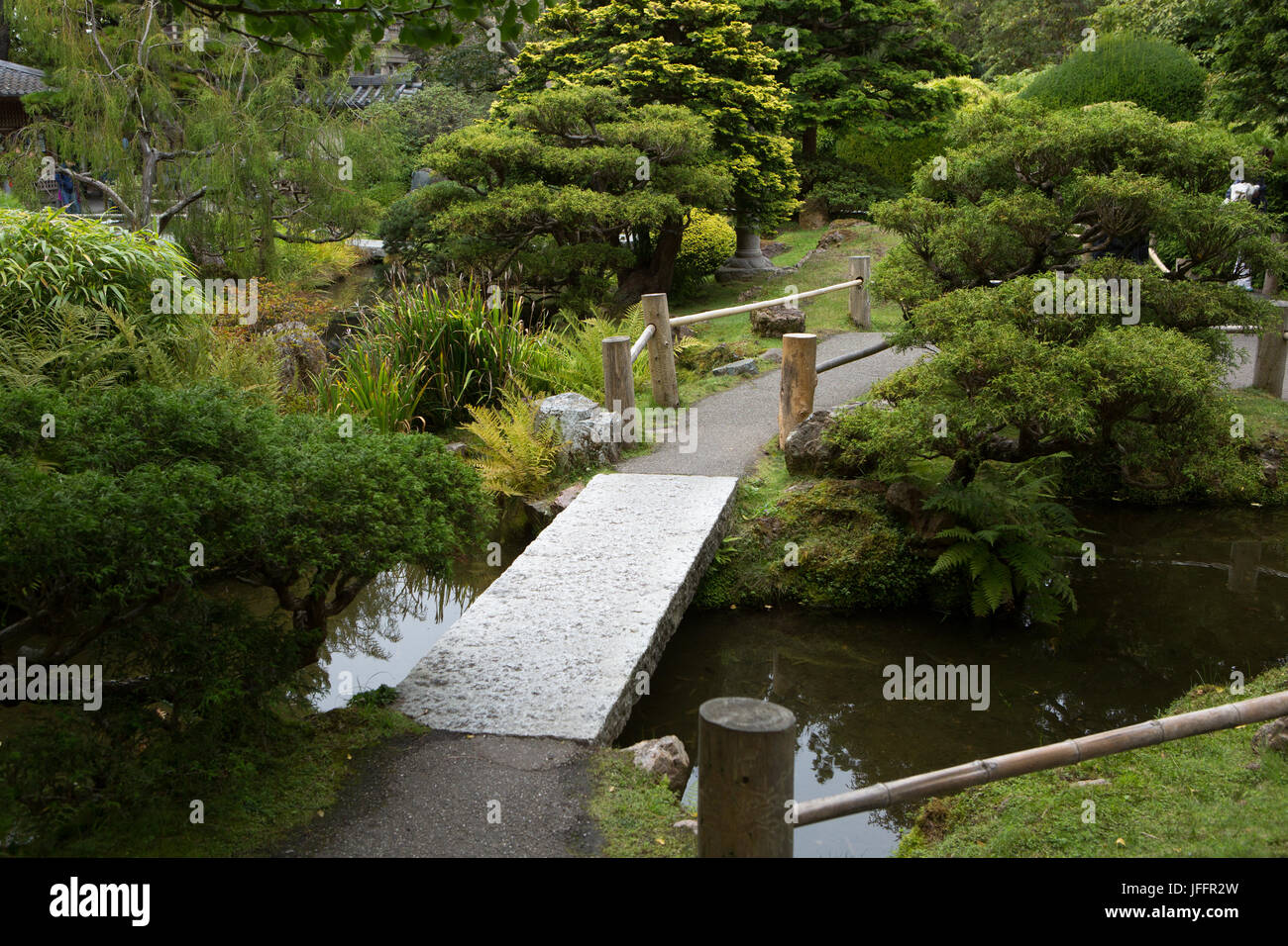 A footbridge, garden and walkway through San Francisco's Japanese Tea Garden. Stock Photo
