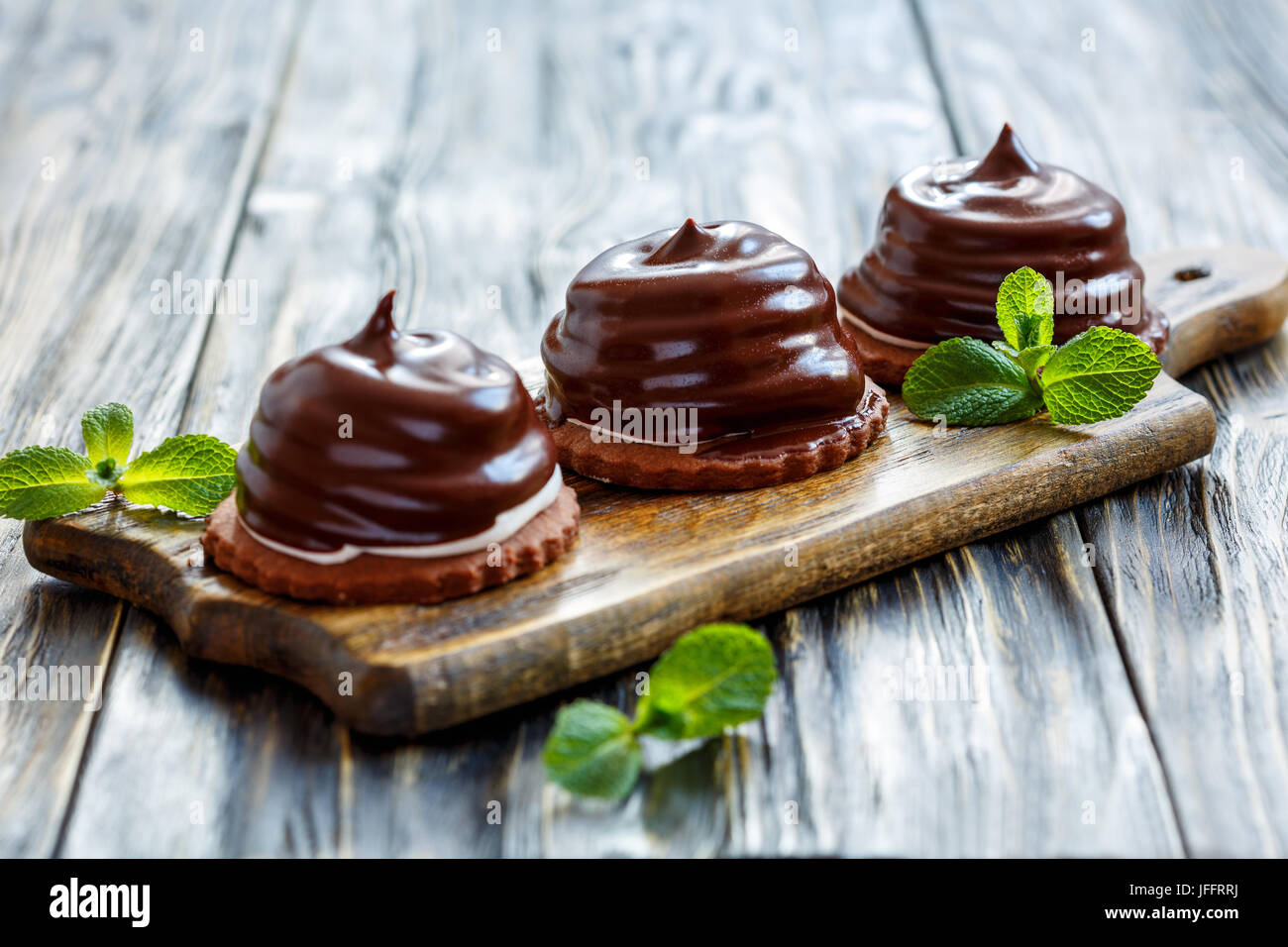Cakes with souffle in chocolate glaze. Stock Photo
