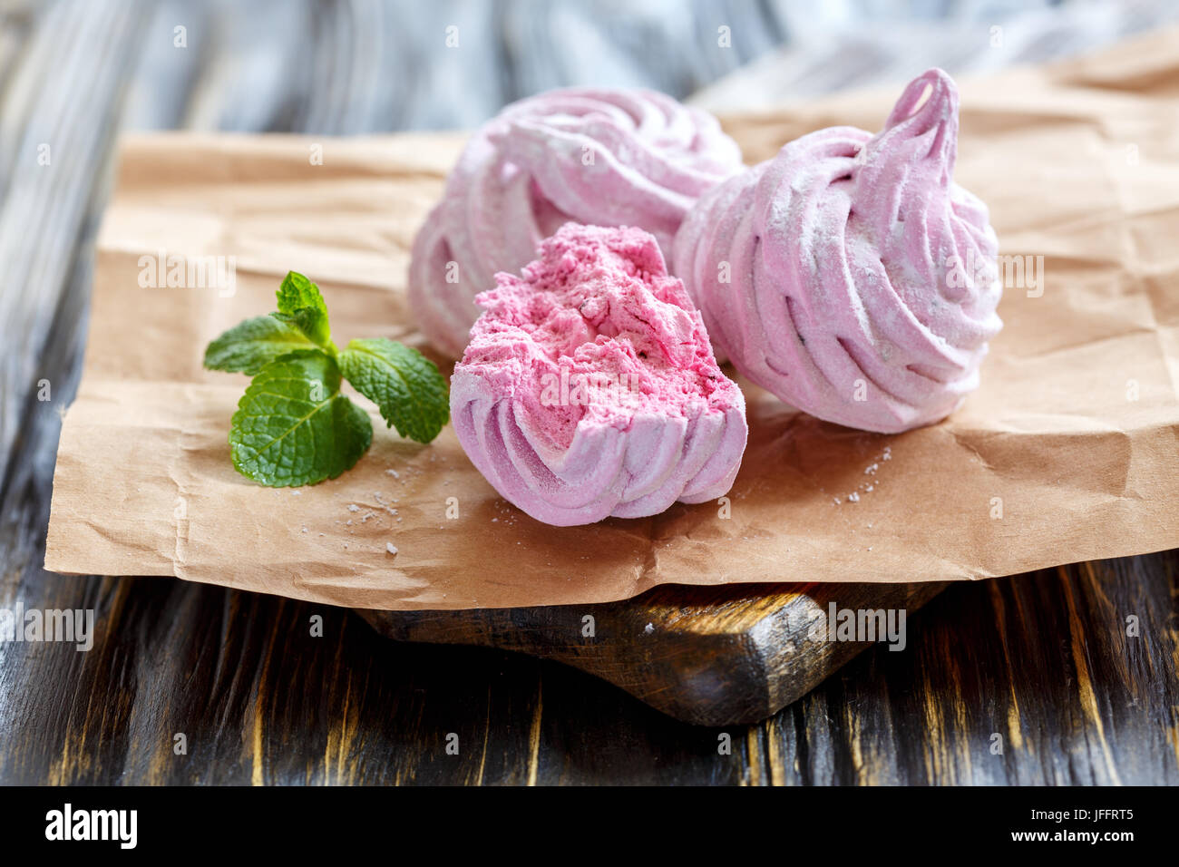 Homemade berry marshmallows and green mint. Stock Photo