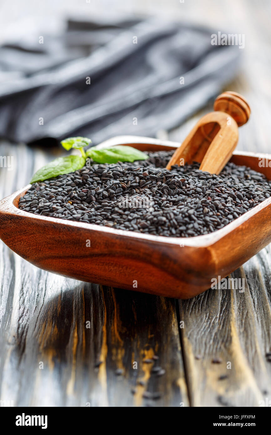 Black sesame in a wooden bowl Stock Photo - Alamy