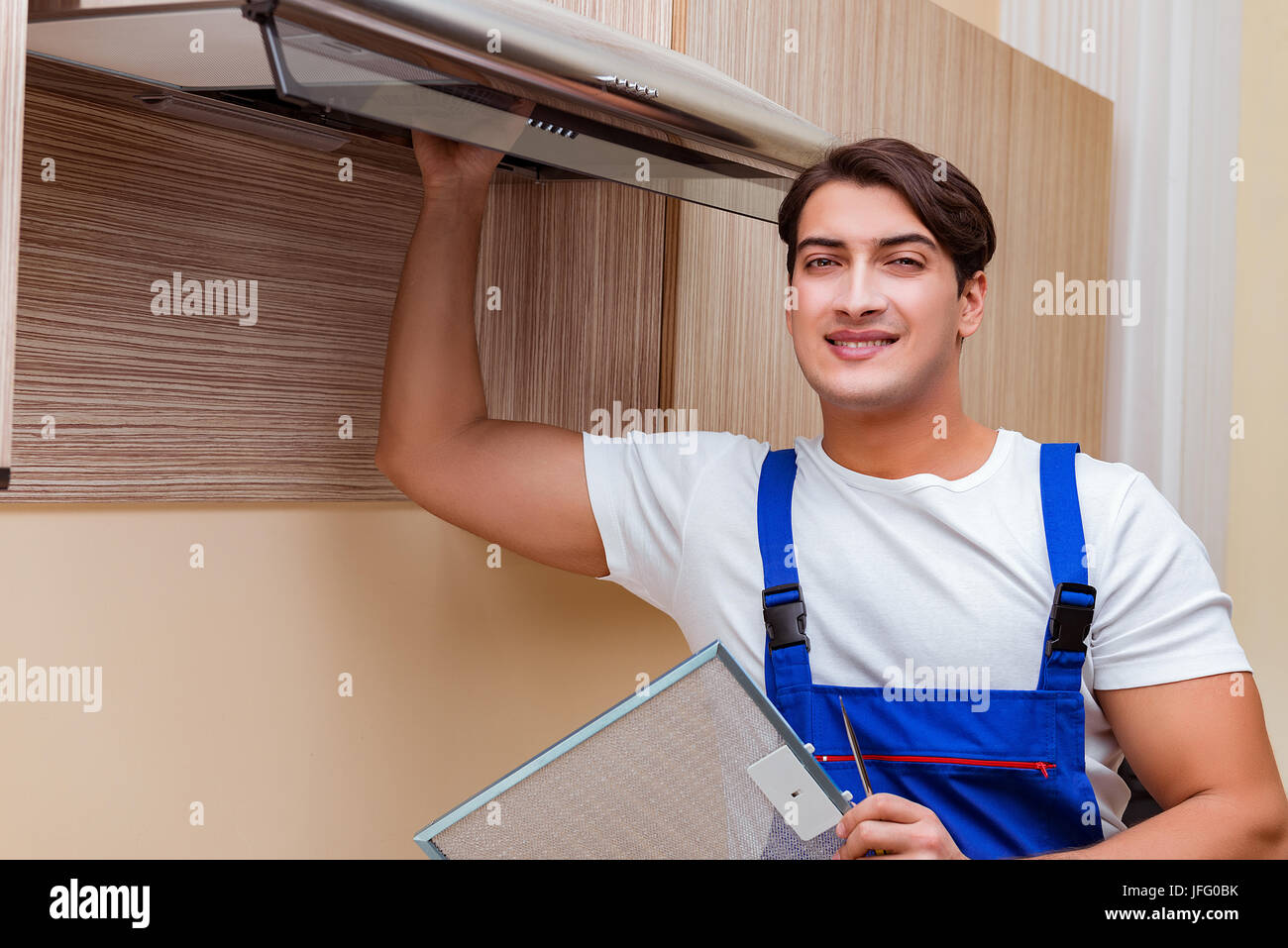 Man Using Kitchen Machine Young man working with kitchen equipment Stock Photo - Alamy