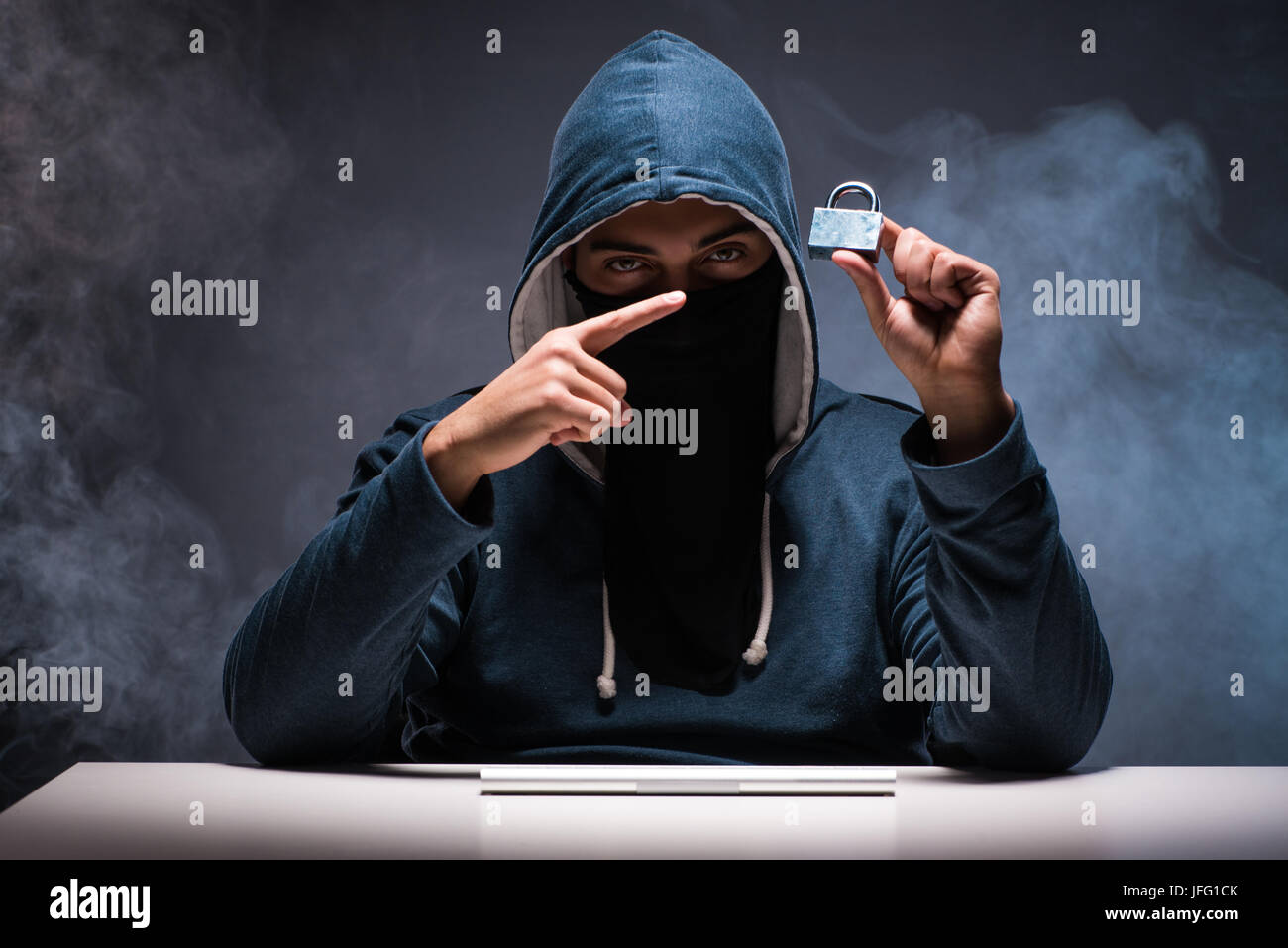 Computer hacker working in dark room Stock Photo - Alamy